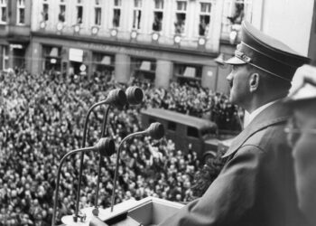 Adolf Hitler speaks to supporters on the balcony during his visit to the third zone of the occupied German territories where he was jubilantly cheered, Oct. 3, 1938, Eger, Hungary. (AP Photo)